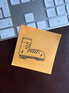 A drawing of a walking boot on a post-it note